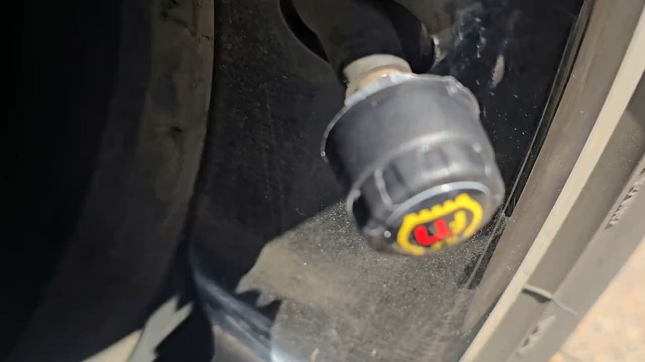 Close-up of an external sensor fitted to a tyre valve.