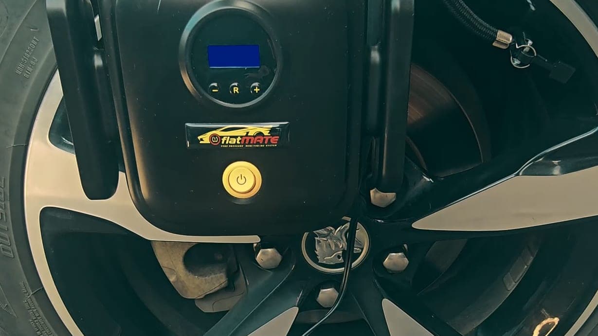 The Surge pump resting against a car wheel.